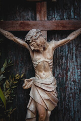 Fototapeta na wymiar Jesus Christ crucified. Close up an ancient wooden statue. Vertical image