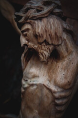Obraz premium Jesus Christ crucified (close up an ancient wooden sculpture) (details) Vertical image