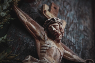 Jesus Christ crucified (close up an ancient wooden sculpture)