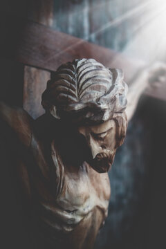 Jesus Christ crucified. Dramatic image of an ancient wooden statue.