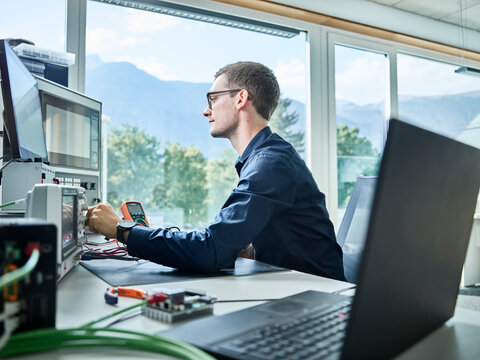 Technician operating machine at table