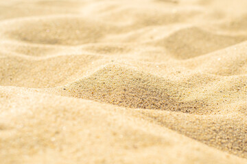 Obraz na płótnie Canvas Close-up of sand on the beach. Toned photo with low depth of field. Small grains of sand on a clean beach.