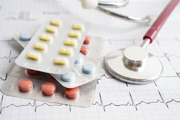 Stethoscope on electrocardiogram (ECG) with drug, heart wave, heart attack, cardiogram report.