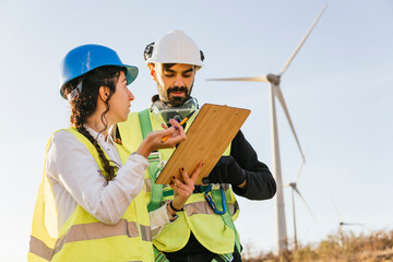 Engineer discussing with technician over document