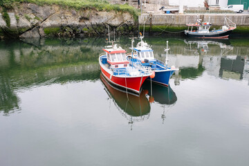 Red and blue boats moored at harbor