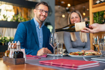 Romantic couple enjoying lunch in the restaurant, eating pizza and drinking wine. Lifestyle, love, relationships, food concept