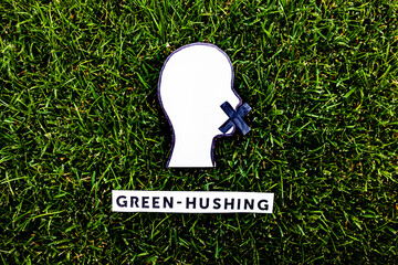 green-hushing companies staying silent about their environmental policies, text and face with mouth...