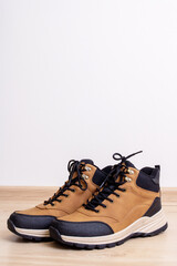 Men's brown boots on a wooden floor