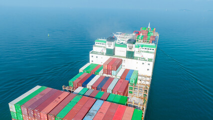 Cargo container Ship, cargo maritime ship with contrail in the ocean ship carrying container and running for export concept technology freight shipping sea freight by Express Ship. Stern View