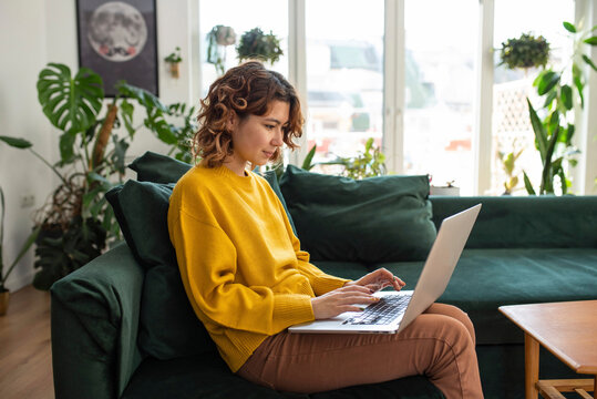 Freelancer Working On Laptop Sitting At Home