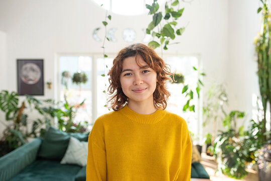 Smiling Young Woman In Living Room At Home