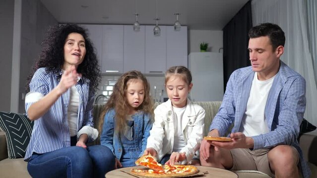Family with excited and amused expression enjoys eating yummy pizza together. Parents and daughters choose tasty pieces of pizza with cheese and tomatoes