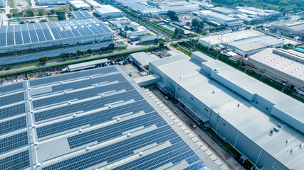 Top view Solar Cell on Warehouse Factory. Solar photo voltaic panels system power or Solar Cell on industrial building roof for producing green ecological electricity. Production of renewable energy.