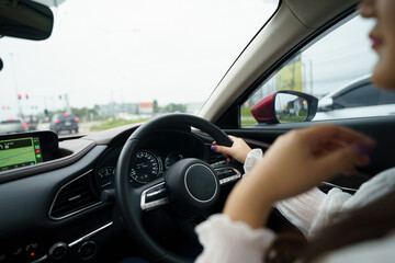 Woman driving car. girl feeling happy to drive holding steering wheel and looking on road.