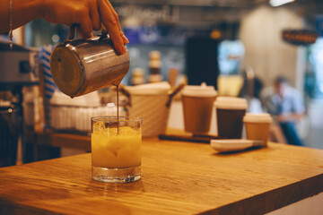 Barista making bumble coffee in cozy atmosphere in small cafe.