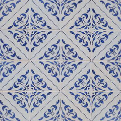 Fragment of building wall with colorful ceramic wall tiles, Azulejo close up. Abstract decorative background, textured ornate pattern for design or backdrop. Traditional ornate Portuguese architecture