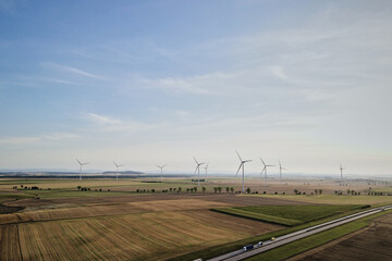 Fototapeta na wymiar Aerial view of windmill turbine generator against beautiful sky in countryside area, Concept of clean, renewable, sustainable, alternative energy