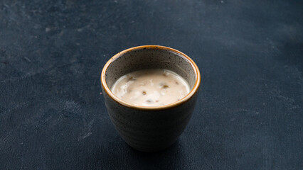White mushroom sauce in a small ceramic bowl.