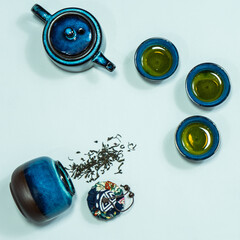 Teapot and cups of Chinese tea on the table for the tea ceremony. Oriental tea set. The concept of a traditional Asian tea ceremony. Blue teapot and teacups on a gray background. Selective focus.
