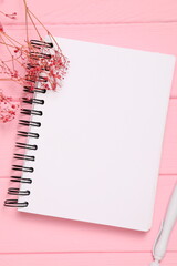 Blank notebook sheet, open page, on wooden background