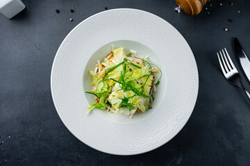 Green salad with cucumbers, ham, eggs, lettuce and greens.