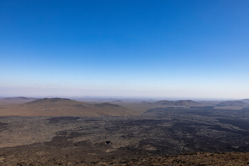 Views across the black lava volcano field of Jabal Qidr in the Harrat Khaybar region, north west Saudi Arabia