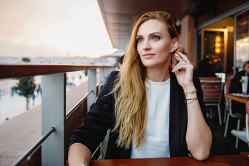 Woman travel in Istanbul and and drink turkey coffee in rooftop cafe near Hagia Sophia famous islamic Landmark mosque, Travel to Istanbul, Turkey background.