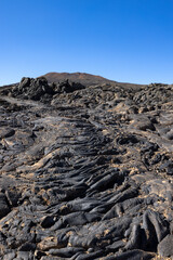 Fototapeta na wymiar Views across the black lava volcano field of Jabal Qidr in the Harrat Khaybar region, north west Saudi Arabia