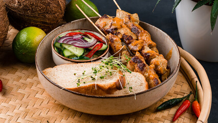 Pork barbecue with fresh vegetable salad with cucumber, chili, onions and bread.