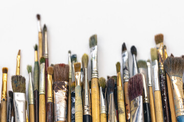 Fototapeta premium Paint brushes of different sizes on a white background isolated.