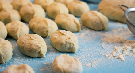 Stuffed pies on the table. The process of cooking pies at home. Close-up. Selective focus.
