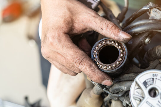 Mechanic inspect and adjust Motorcycle Steering Head Bearings, maintenance, repair motorcycle concept in garage .selective focus