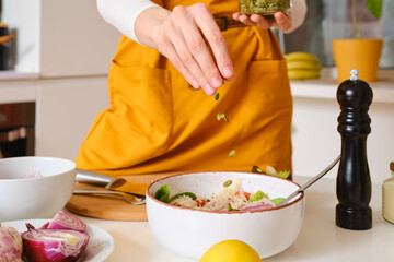 Closeup view of adding pumpkin seeds to salad