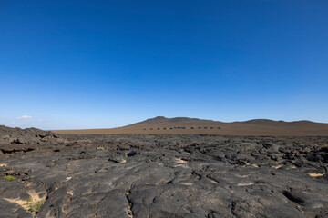 Views across the black lava volcano field of Jabal Qidr in the Harrat Khaybar region, north west Saudi Arabia