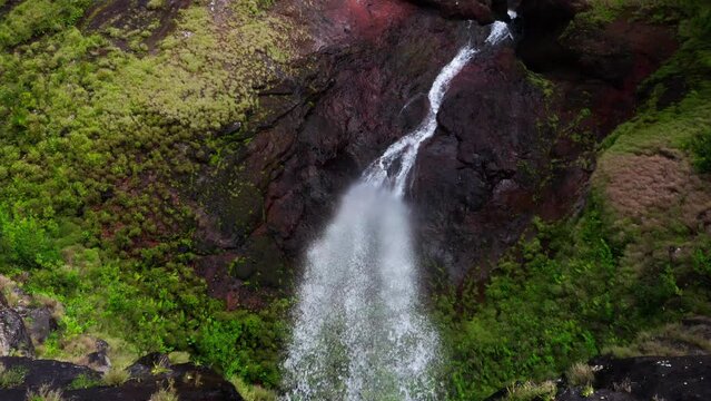 Picturesque flying over the mountain creek fall down from steep high cliff to wide valley. Cascade 500 Pieds waterfall on Mauricius island in Indian ocean.