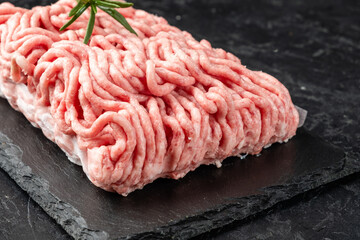 Raw minced meat fresh close-up on a dark background.
