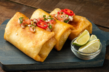 Chimichanga three pieces close-up, Mexican cuisine.