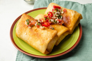 Chimichanga is a close-up Mexican dish with chili pepper and salsa.