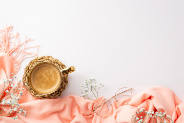 Hello spring concept. Top view photo of cup of hot drinking on rattan placemat pink scarf stylish glasses and gypsophila flowers on isolated white background with empty space