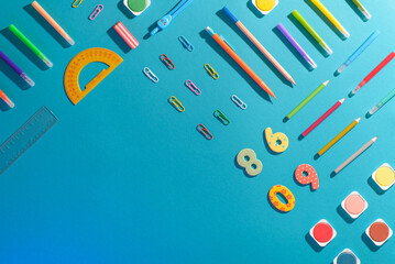 Flat lay with different school supplies on colored background. Copy space. Top view.