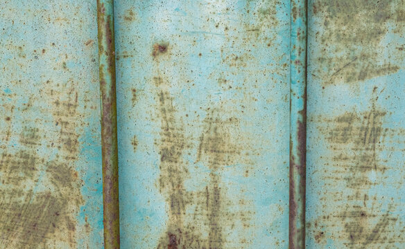 Patina blue and rusted metal panel with two rods grunge background texture © Jane Karelas