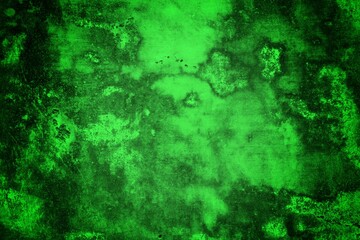 Obraz premium A textured green grunge background with dark patches and rough surface