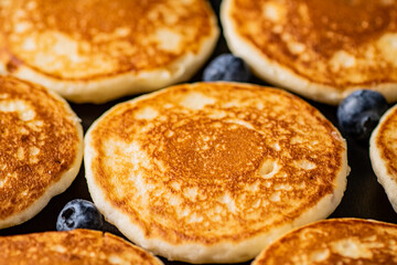 Pancakes with fresh blueberries. Macro background.