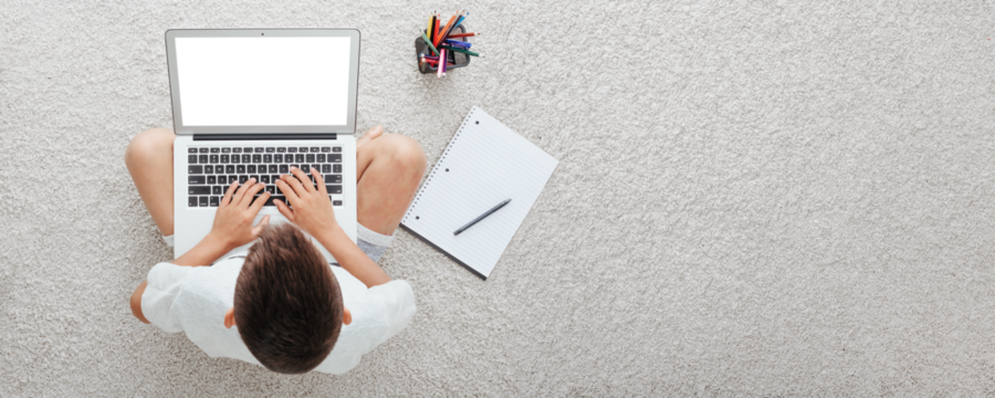 school at home through online homeschooling. the child is sitting at the computer