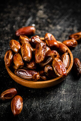 Ripe dates on a plate on the table. 