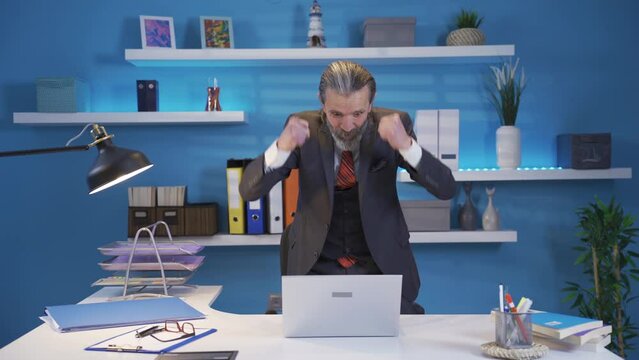 The mature businessman rejoicing at the good news is overjoyed and happy.
The mature businessman working on the laptop sees the good news and starts to rejoice like crazy.
