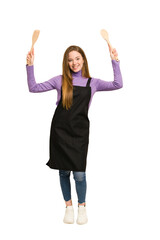Young novice redhead woman with apron and wooden spoon and fork cut out isolated