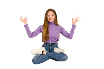 Obraz premium Young redhead woman sitting isolated cut out