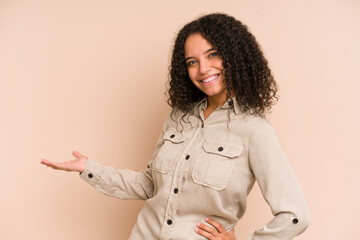 Young african american curly woman isolated showing a welcome expression.