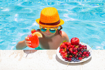 Child in swimming pool with fruits. Summer kids activity. Summer vacation. Healthy kids lifestyle.